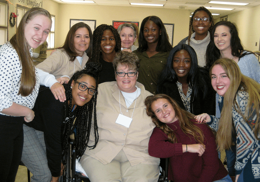 Mercer students and women incarcerated at Pulaski State Prison pose for photos during their last ‘Building Community/Inside-Out’ class together on Dec. 7.
