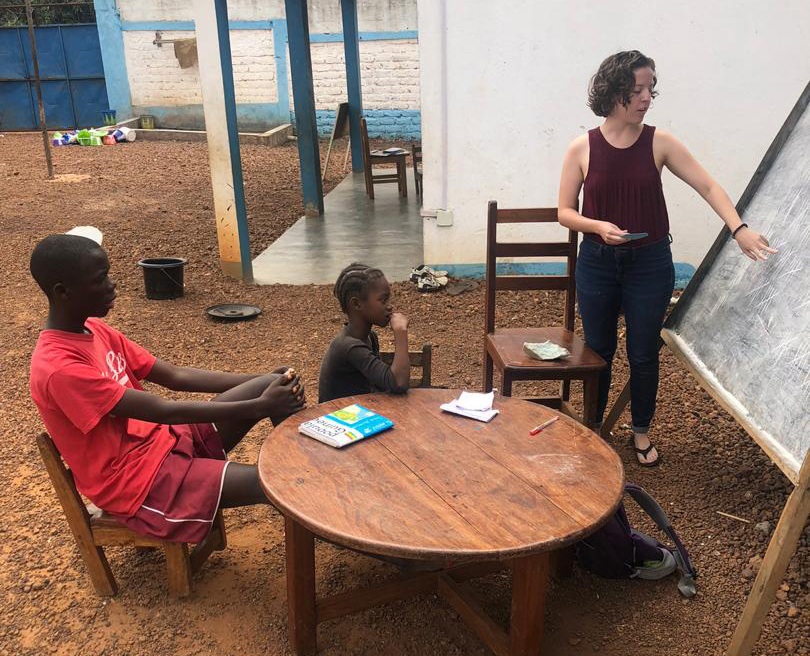 Sarah Harris, right, tutors children at Home of Hope orphanage in Guinea for her internship in spring 2019.
