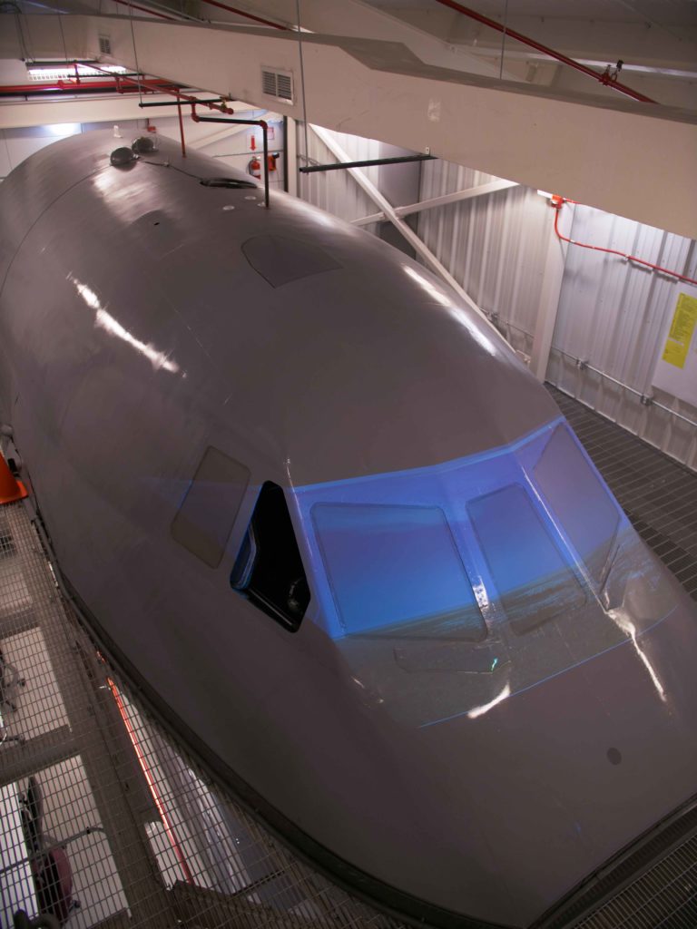 The front end of a C-5 has been set up inside a building at Robins Air Force Base and wired to simulate outside elements.
