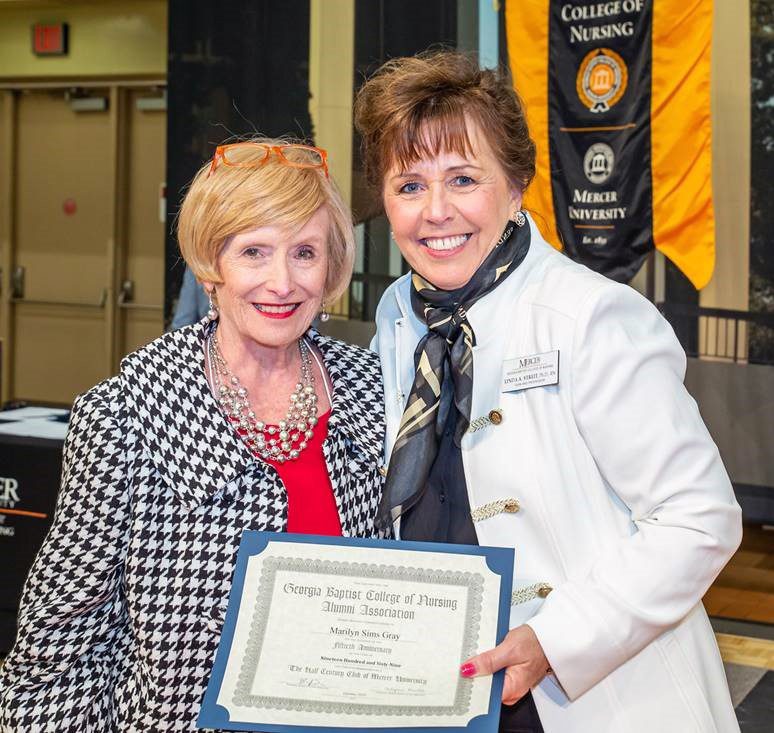 Marilyn Gray, left, is presented with an alumni award from College of Nursing Dean Linda Streit.